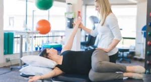 PT helping patient in a stretch